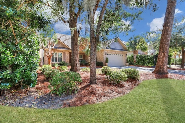 view of front of property featuring a garage, driveway, a front lawn, and brick siding