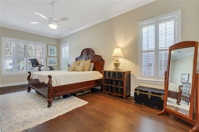 bedroom with dark wood-style flooring, crown molding, baseboards, and ceiling fan