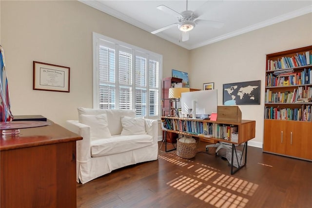 sitting room featuring baseboards, ornamental molding, dark wood finished floors, and a ceiling fan