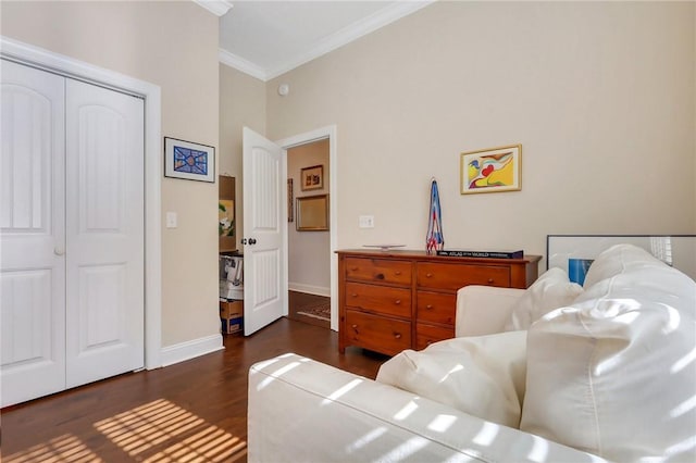 interior space featuring dark wood-style floors, a closet, baseboards, and crown molding