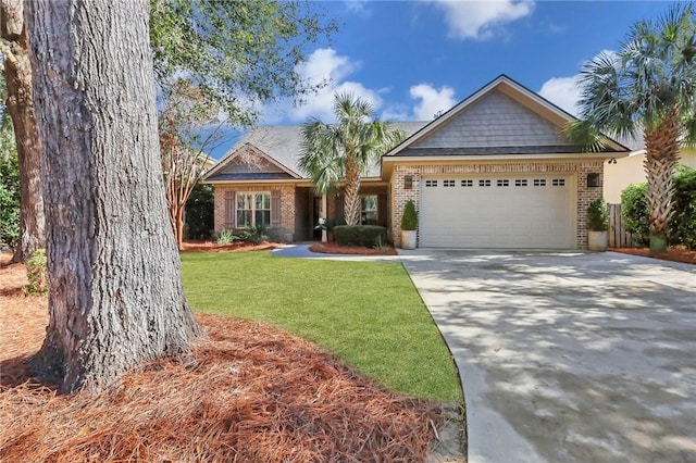 craftsman-style house featuring a garage, a front yard, concrete driveway, and brick siding