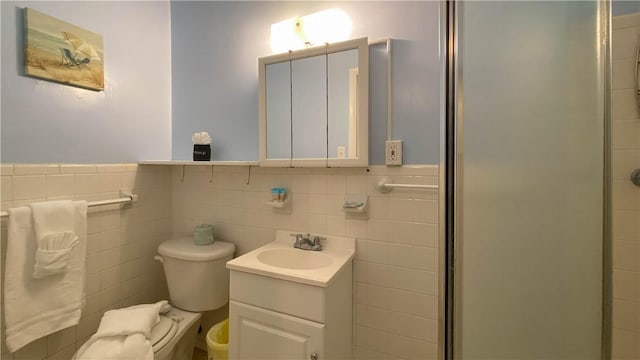 3 Porter Ln, Jekyll Island, GA 31527 - full bathroom with vanity, a shower stall, tile walls, and a wainscoted wall
