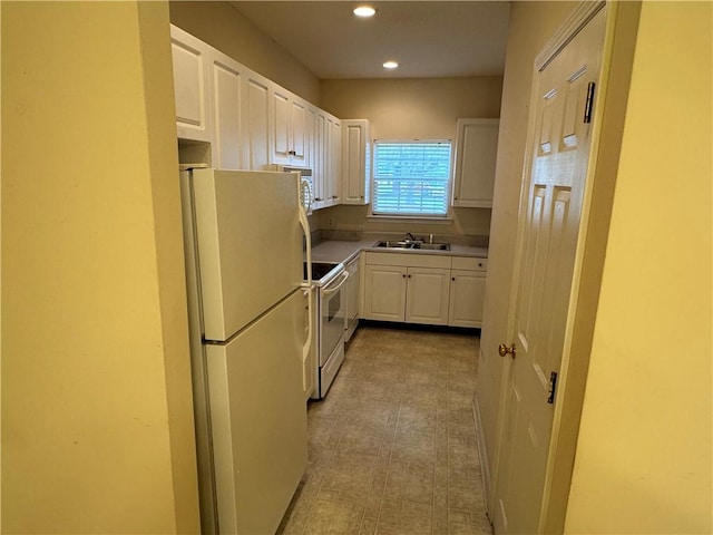 448 Moss Creek Ln, Brunswick, GA 31520 - kitchen with white appliances, white cabinetry, recessed lighting, light floors, and light countertops