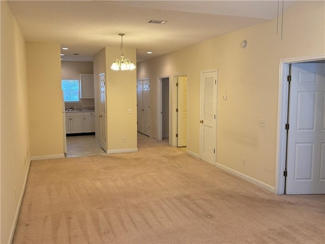448 Moss Creek Ln, Brunswick, GA 31520 - unfurnished room featuring light carpet and a chandelier