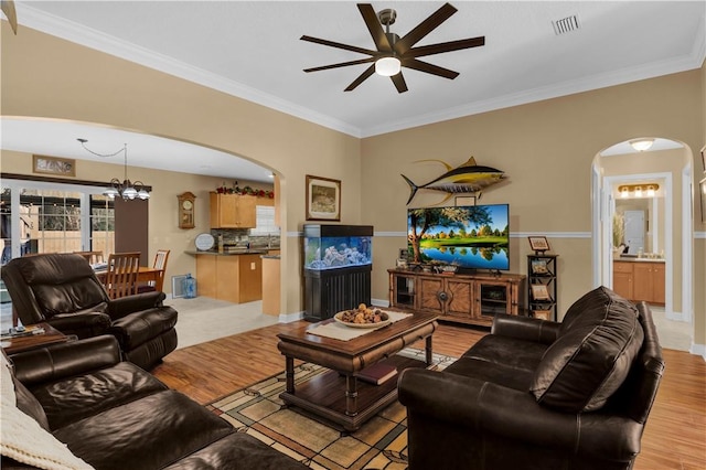 living room with ornamental molding and light wood-type flooring