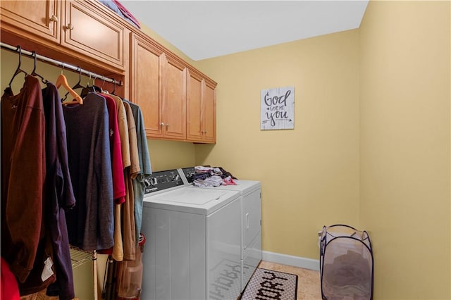 washroom featuring cabinets and washer and dryer