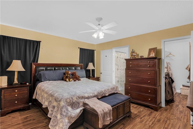 bedroom with ensuite bath, dark hardwood / wood-style floors, and ceiling fan