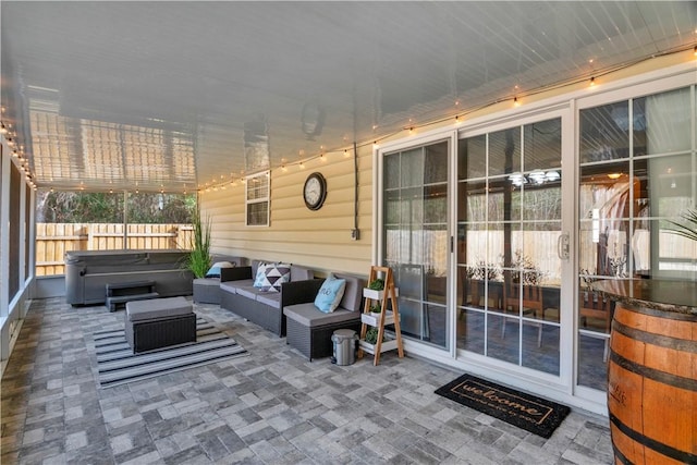 view of patio with an outdoor living space and a hot tub