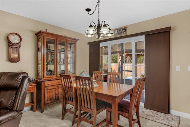 dining area with an inviting chandelier and light tile patterned floors