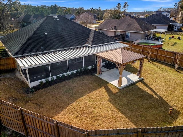 exterior space with a patio, a sunroom, and a lawn