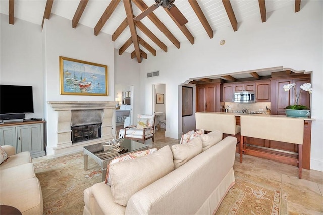 living room featuring ceiling fan, beam ceiling, and high vaulted ceiling