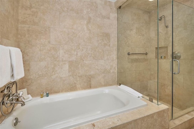 bathroom featuring separate shower and tub