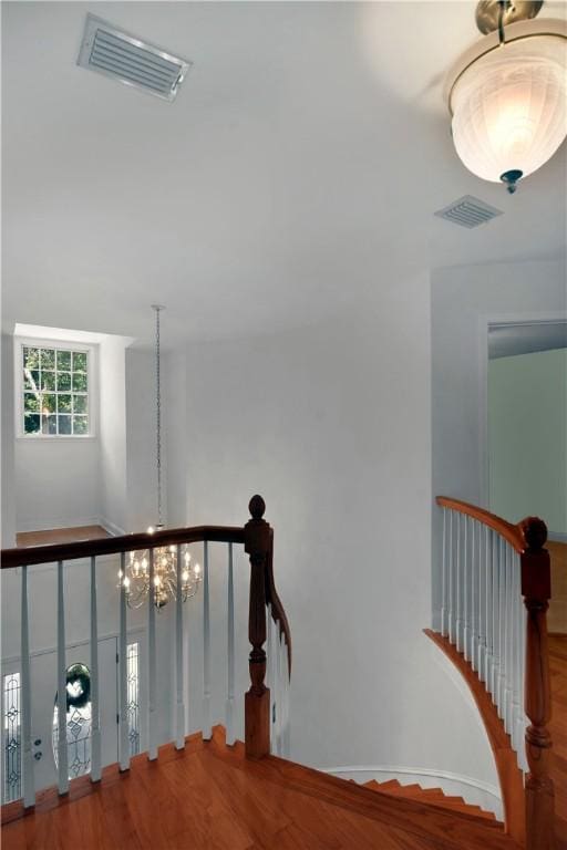 103 Bellrain Ln, Saint Simons Island, GA 31522 - stairway with wood finished floors and a chandelier