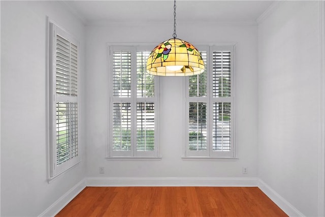 103 Bellrain Ln, Saint Simons Island, GA 31522 - unfurnished dining area featuring wood finished floors and crown molding