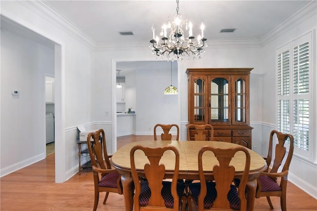 103 Bellrain Ln, Saint Simons Island, GA 31522 - dining space with a chandelier, light wood-type flooring, and crown molding