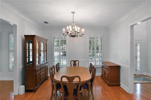 103 Bellrain Ln, Saint Simons Island, GA 31522 - dining area with a chandelier, light wood-type flooring, plenty of natural light, and ornamental molding
