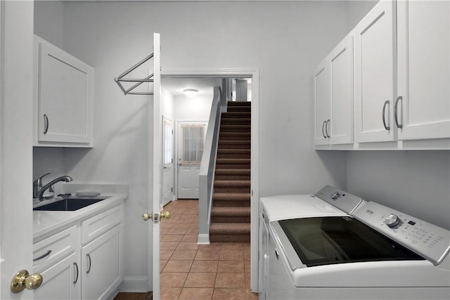 103 Bellrain Ln, Saint Simons Island, GA 31522 - washroom featuring independent washer and dryer, cabinet space, and light tile patterned flooring