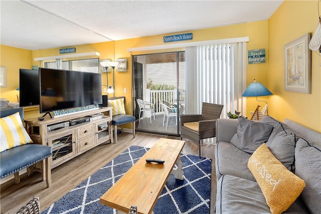 1524 Wood Ave Unit 115, Saint Simons Island, GA 31522 - living area with wood finished floors and a textured ceiling