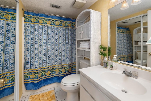 bathroom featuring vanity, tile patterned floors, a shower with shower curtain, toilet, and a textured ceiling