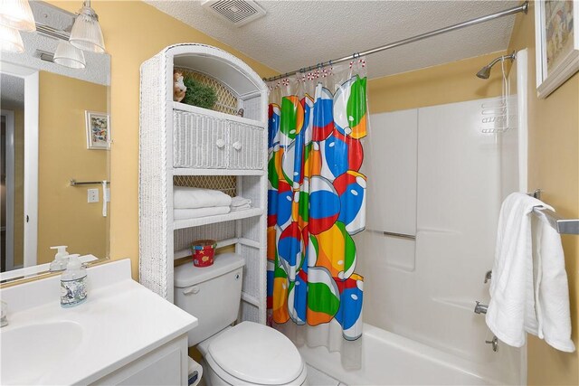 full bathroom with vanity, toilet, a textured ceiling, and shower / tub combo