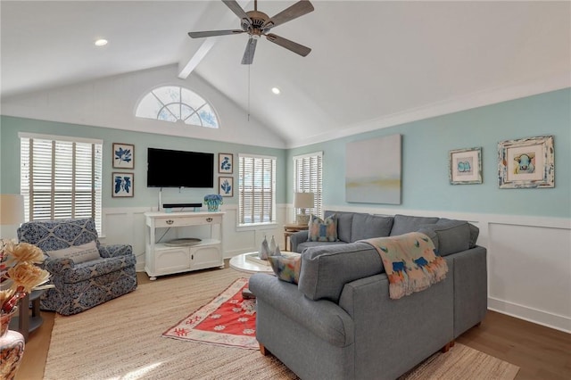 living area featuring a ceiling fan, a wainscoted wall, wood finished floors, vaulted ceiling with beams, and recessed lighting