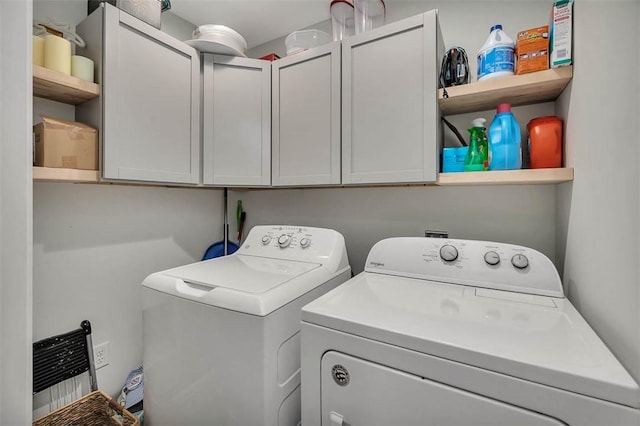 laundry area with cabinet space and separate washer and dryer