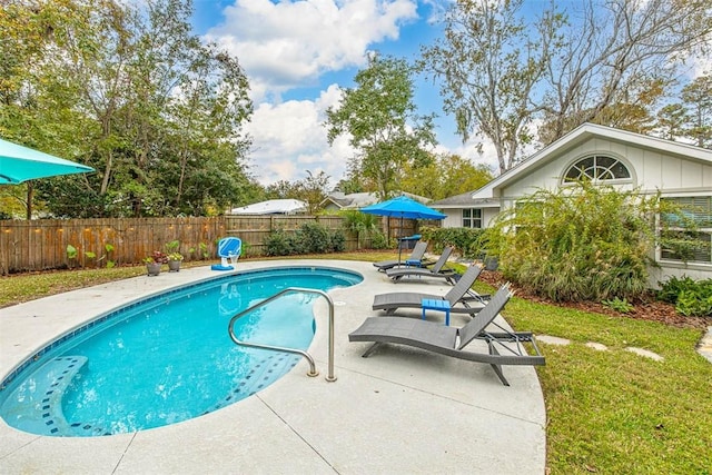 view of pool with a patio area, a fenced backyard, a fenced in pool, and a yard