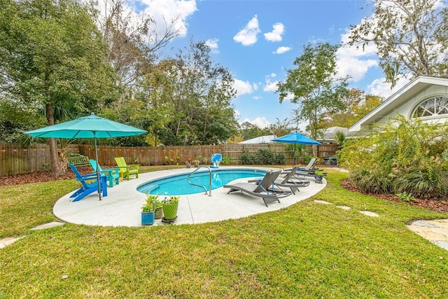 view of swimming pool featuring a patio area, a fenced backyard, and a yard