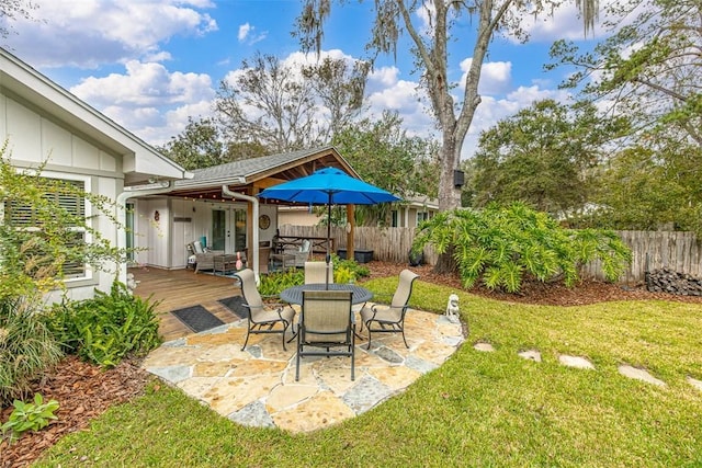 view of yard with fence and a deck