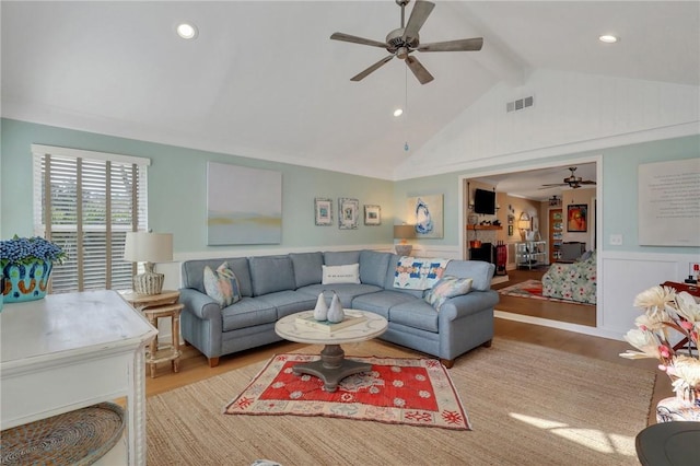 living area featuring lofted ceiling with beams, recessed lighting, wood finished floors, visible vents, and a ceiling fan