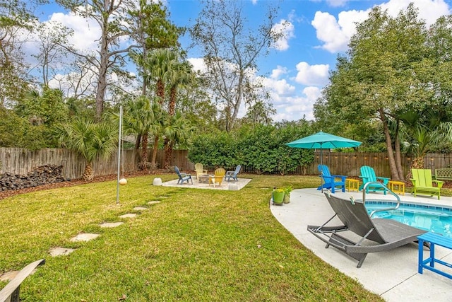 view of yard featuring a fenced in pool, an outdoor fire pit, a fenced backyard, and a patio