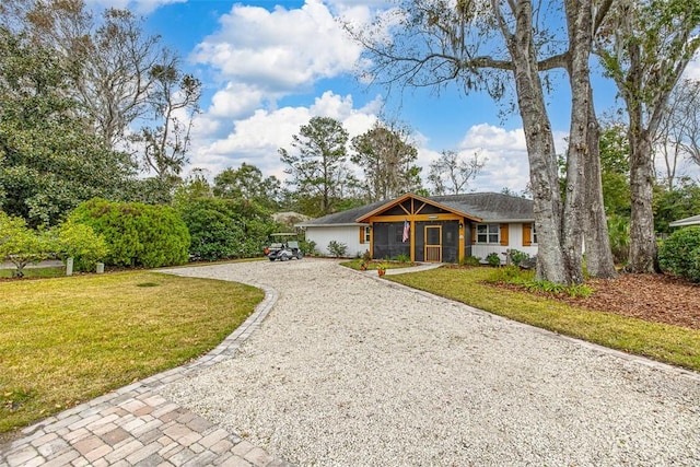 view of front of home with driveway and a front lawn