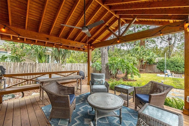 wooden deck with a gazebo, a lawn, a fenced backyard, and a ceiling fan