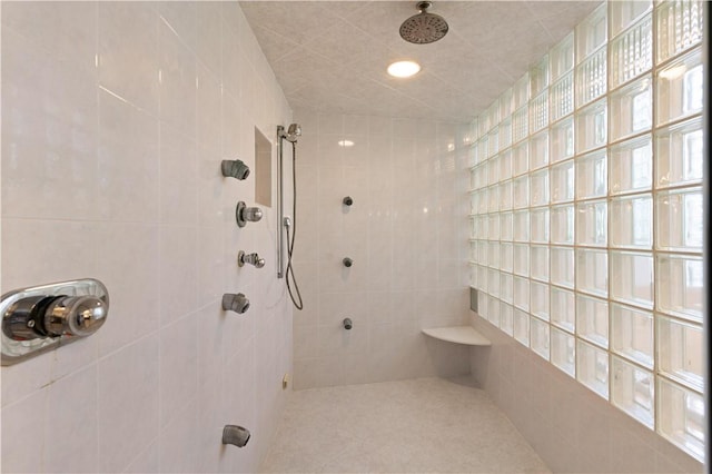316 Forest Oaks, Saint Simons Island, GA 31522 - bathroom featuring a tile shower and tile walls