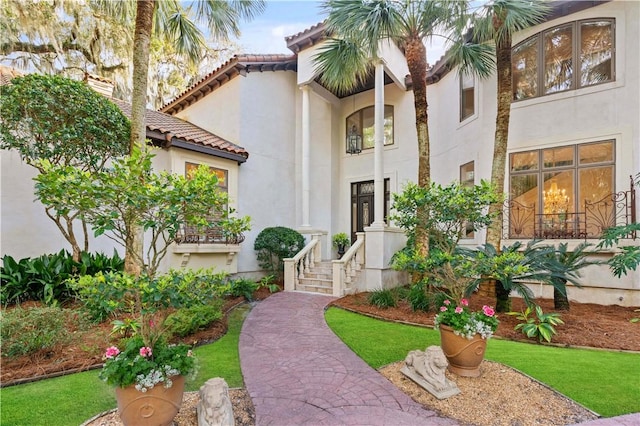 view of front of property with a tiled roof and stucco siding