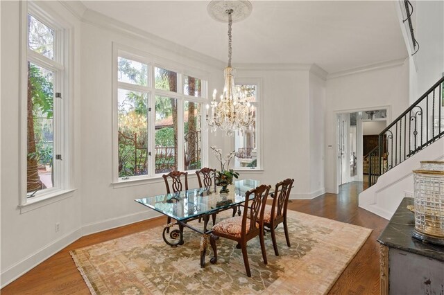 316 Forest Oaks, Saint Simons Island, GA 31522 - dining area with a chandelier, wood finished floors, baseboards, and stairs