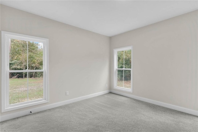 carpeted empty room featuring a healthy amount of sunlight