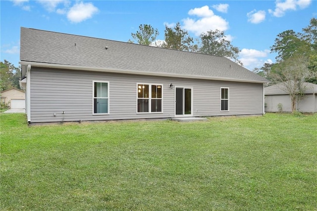 rear view of property featuring a yard