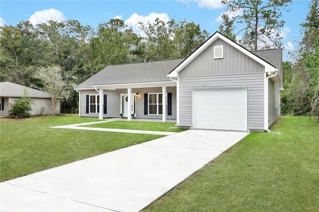 view of front of house featuring covered porch, a garage, and a front yard