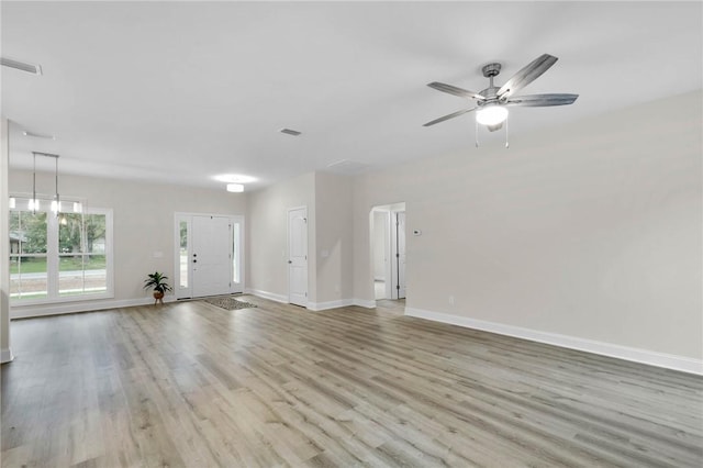 empty room featuring ceiling fan and light hardwood / wood-style floors