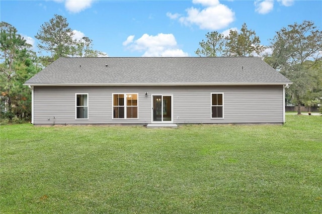 rear view of property featuring a yard