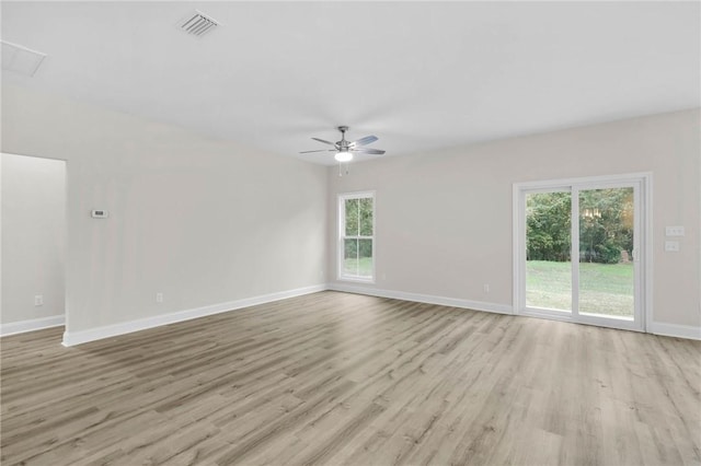 unfurnished room featuring ceiling fan, a healthy amount of sunlight, and light wood-type flooring