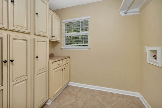 212 Stillwater Dr, Brunswick, GA 31525 - laundry room with light tile patterned flooring, hookup for a washing machine, baseboards, and cabinet space