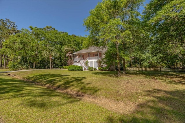212 Stillwater Dr, Brunswick, GA 31525 - view of yard with stairway, covered porch, and fence