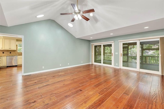 212 Stillwater Dr, Brunswick, GA 31525 - unfurnished living room with light wood finished floors, vaulted ceiling, ceiling fan, and a healthy amount of sunlight