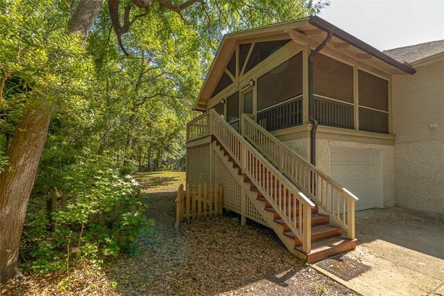 212 Stillwater Dr, Brunswick, GA 31525 - exterior space featuring a garage, a sunroom, concrete driveway, and stairway