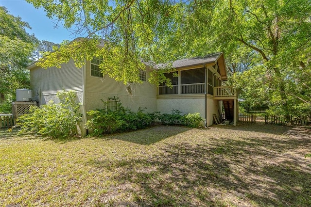 212 Stillwater Dr, Brunswick, GA 31525 - view of side of property featuring a sunroom, fence, and a lawn