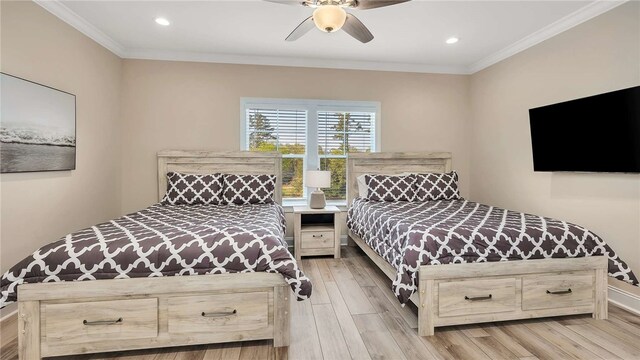 bedroom with ceiling fan, crown molding, and light hardwood / wood-style flooring