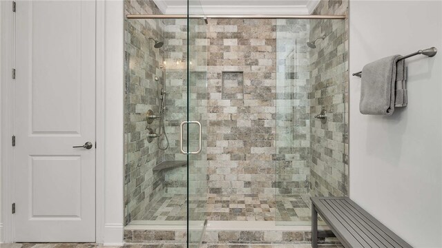 bathroom featuring a shower with shower door