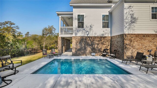 view of swimming pool featuring a patio area and ceiling fan